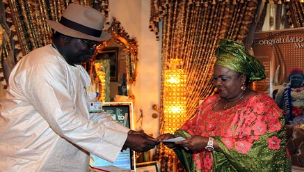 (L-r): Barrister Chris  Onyemenam, director general/CEO of NIMC, handing the First Lady, Dame Patience Jonathan her National e-ID Card at the State house Abuja recently.